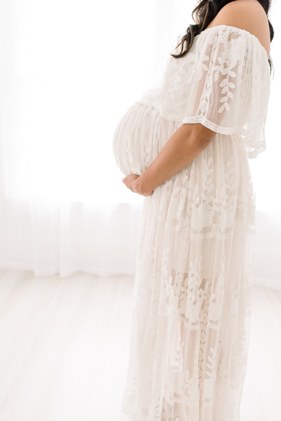 Mom in white dress during photo session with Houston maternity photographer