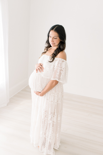 Mom in white dress during photo session with Houston maternity photographer